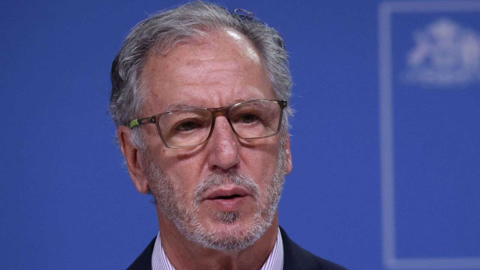 Ministro Álvaro García con un fondo azul tras su espalda.